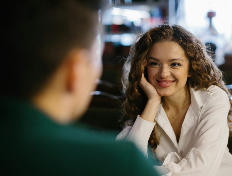 Young woman and man flirting each other in cafe