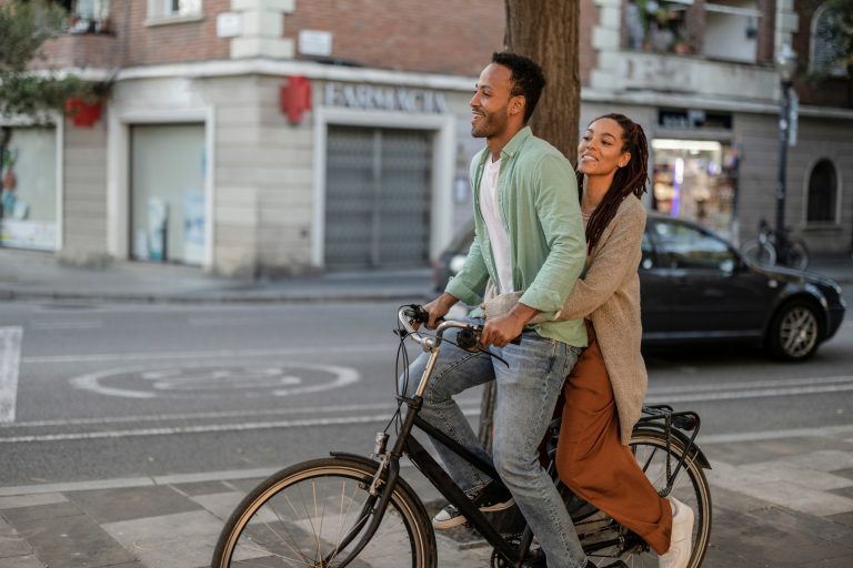 happy tourist couple on electric bike, african american couple in the city