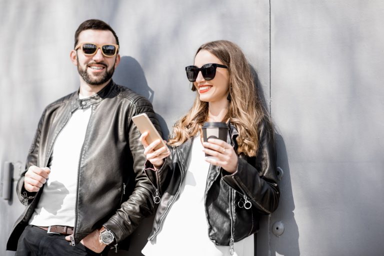 Stylish couple on the grey background